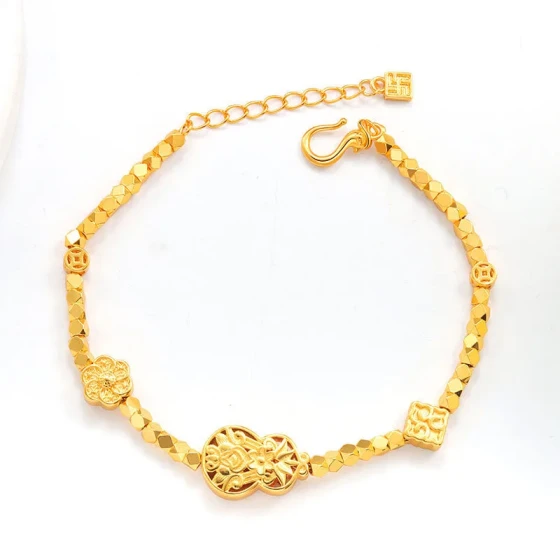Ancient-style gold-plated light luxury bracelet with fragmented gold and ancient coin patterns, small flowers, and heart designs in gold color, a fashionable and elegant piece for women